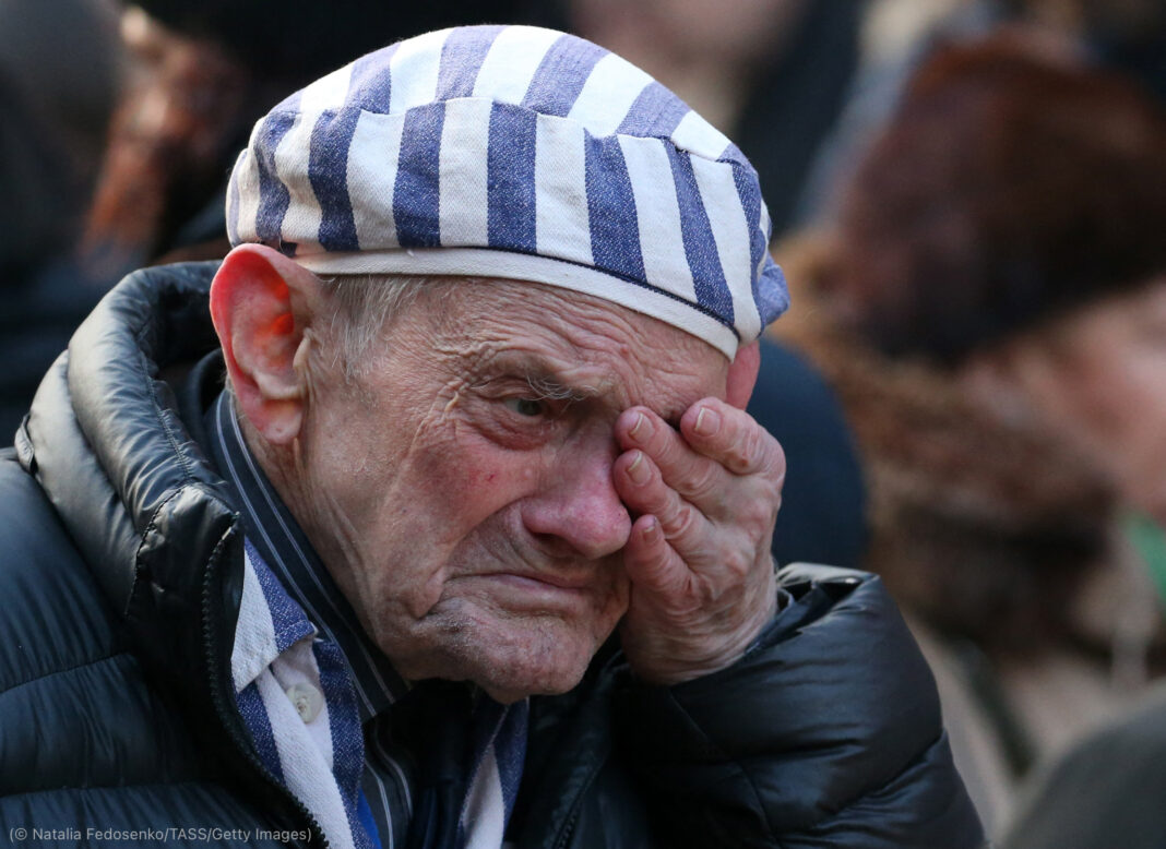 OSWIECIM, POLAND - JANUARY 27, 2020: A man mourning during a ceremony to lay flowers at the Death Wall at the former Auschwitz concentration camp operated by Nazi Germany during WWII. Over a million Jews, as well as Soviet and Polish prisoners, were killed in the camp's gas chambers to be burnt in crematoria. Auschwitz was liberated by the Soviet Red Army on 27 January 1945; in 1947, the Polish government founded the Auschwitz-Birkenau State Museum on the site of the camp, which in 1979 was inscribed on the UNESCO World Heritage Site List. In 2005, January 27 was named International Holocaust Remembrance Day by the General Assembly of the United Nations. Natalia Fedosenko/TASS (Photo by Natalia FedosenkoTASS via Getty Images)